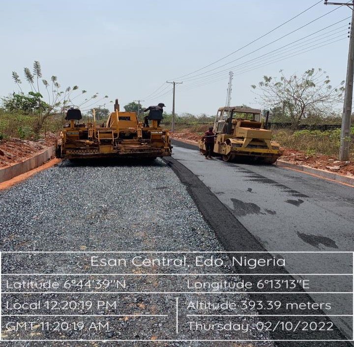 Asphalt paver and compaction roller during road construction, Irrua township roads rehabilitation, Edo State